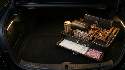 Trunk of a car with luxurious items including a suitcase, wallet, and cards.