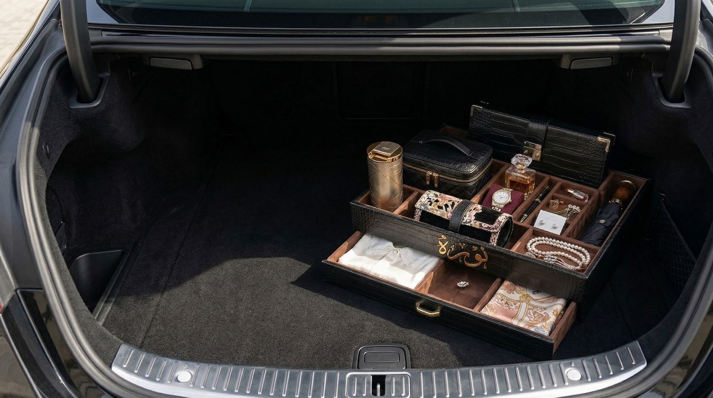 Trunk of a car with a wooden jewelry box and accessories inside