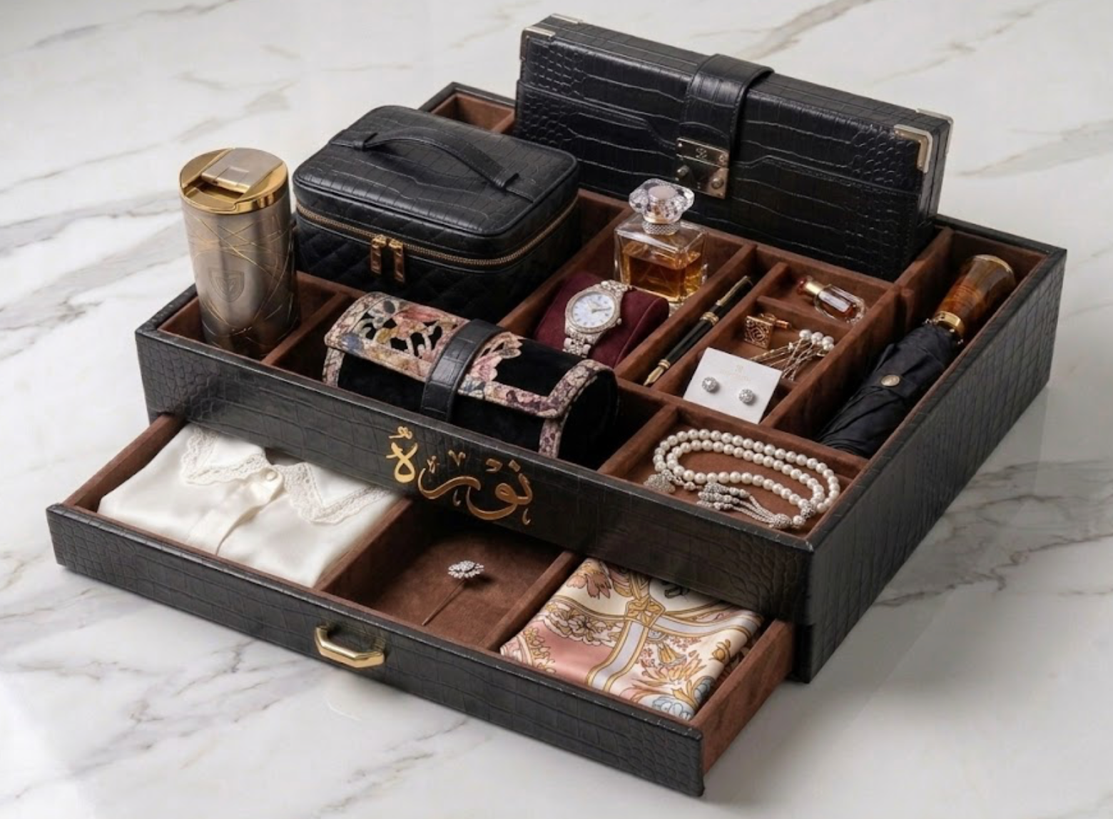 Organized jewelry and accessory drawer set on a marble surface